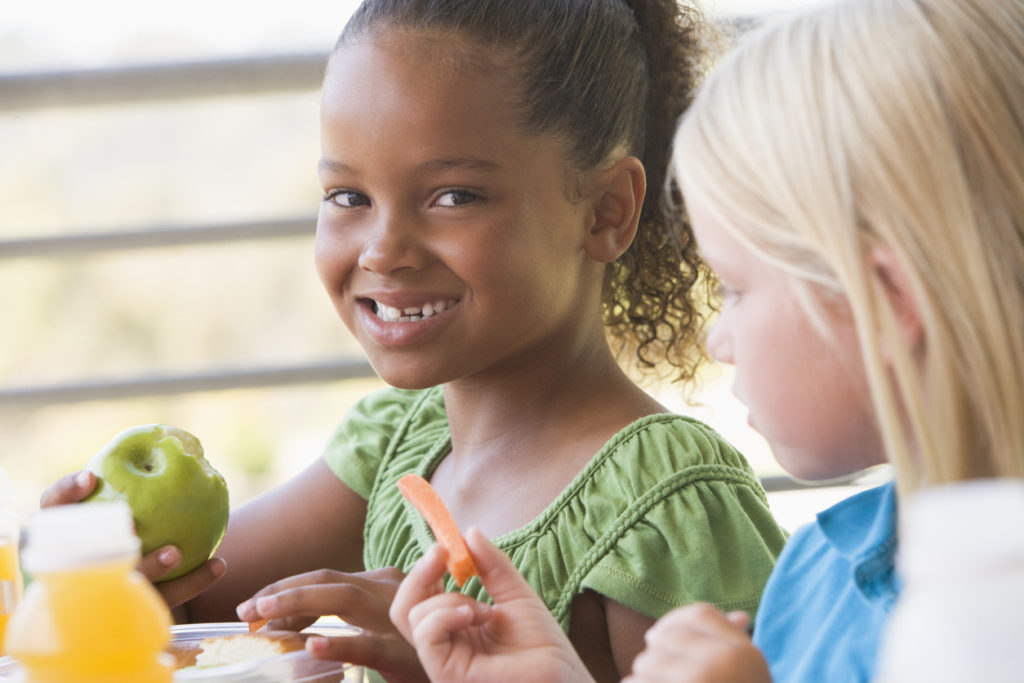 Two girls in kindergarten eating lunch